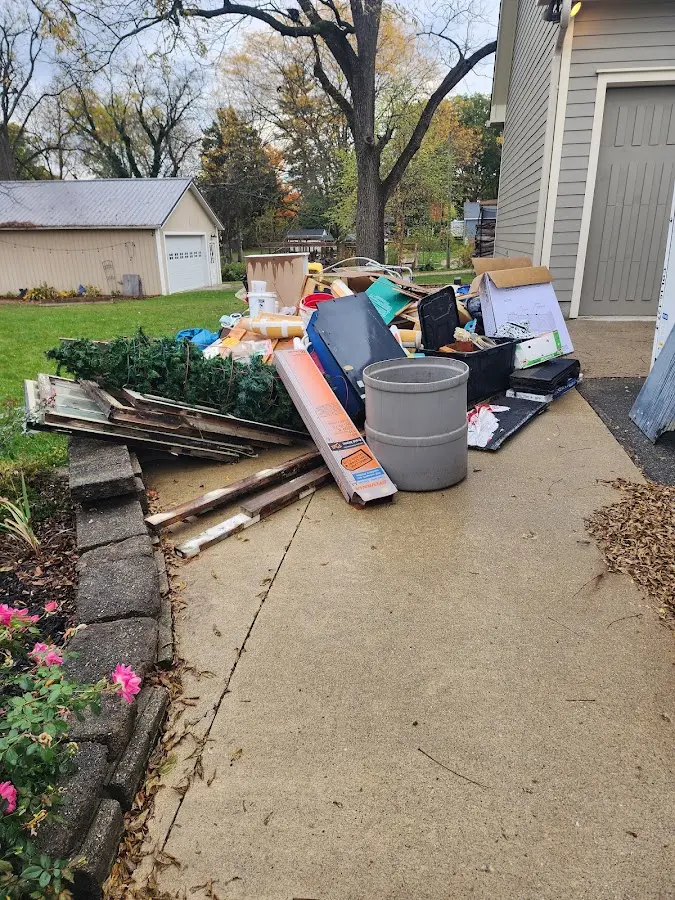 Dumpster being loaded with debris for Roofing Dumpster Rental in Green Oaks